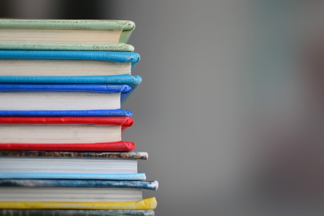 A stack of books with different brightly coloured covers